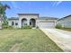 Single-story house with a two-car garage and nicely landscaped yard at 1870 Dumbleton Pl, St Cloud, FL 34771