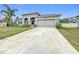 Single-story home with attached garage and manicured lawn at 1870 Dumbleton Pl, St Cloud, FL 34771