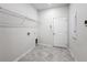 Bright laundry room with built-in shelving and tile floor at 1870 Dumbleton Pl, St Cloud, FL 34771