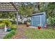 Landscaped backyard with shed and deck at 1871 Linden Rd, Winter Park, FL 32792