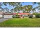 Cute ranch home with a red door and nicely landscaped lawn at 1871 Linden Rd, Winter Park, FL 32792