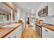 Modern white kitchen with wood countertops and stainless steel appliances at 1871 Linden Rd, Winter Park, FL 32792