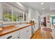 Modern white kitchen with wood countertops and stainless steel appliances at 1871 Linden Rd, Winter Park, FL 32792