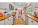 Modern white kitchen with wood countertops and stainless steel appliances at 1871 Linden Rd, Winter Park, FL 32792