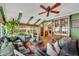 Relaxing living room with green walls, leather sofas, and a view of the backyard at 1871 Linden Rd, Winter Park, FL 32792