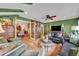 Cozy living room with green walls, leather sofa, and ceiling fan at 1871 Linden Rd, Winter Park, FL 32792