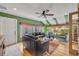 Comfortable living room with green walls, leather seating, and hardwood floors at 1871 Linden Rd, Winter Park, FL 32792