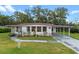 Single-wide manufactured home with carport and mature landscaping at 2010 Brookside Dr, Mount Dora, FL 32757