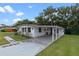 Single story home with carport and landscaped yard at 2010 Brookside Dr, Mount Dora, FL 32757