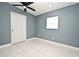 Bright bedroom with ceiling fan, tiled floors, and an ensuite bathroom at 2090 Ashland Blvd, Orlando, FL 32808