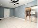 Bedroom with ceiling fan, tiled floors, and access to living area at 2090 Ashland Blvd, Orlando, FL 32808