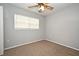 Bright bedroom with neutral walls, ceiling fan, and carpet flooring at 2090 Ashland Blvd, Orlando, FL 32808