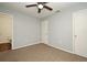 Bedroom with neutral walls, ceiling fan, and carpet flooring, plus access to a bathroom at 2090 Ashland Blvd, Orlando, FL 32808