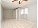 Well-lit bedroom featuring tile flooring, a ceiling fan, and built-in closet at 2090 Ashland Blvd, Orlando, FL 32808