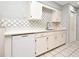 White kitchen cabinets with quartz countertops and a dishwasher at 2090 Ashland Blvd, Orlando, FL 32808