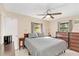 Comfortable bedroom with a gray comforter and wood dresser at 2100 Suffield Dr, Winter Park, FL 32792