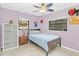 Bright bedroom with a twin bed, ceiling fan, and ample closet space at 2100 Suffield Dr, Winter Park, FL 32792