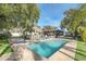 Inviting rectangular pool with patio and tropical landscaping at 2100 Suffield Dr, Winter Park, FL 32792