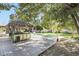 Backyard oasis with a tiki bar and lush landscaping at 2100 Suffield Dr, Winter Park, FL 32792