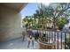 Relaxing balcony with wicker chairs and a view of palm trees and a residential street at 2409 Kilgore St, Orlando, FL 32803