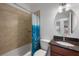 Clean bathroom with a tub shower, granite vanity, and patterned shower curtain at 2409 Kilgore St, Orlando, FL 32803