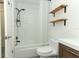 Updated bathroom with subway tile, wood vanity, and floating shelves at 2580 Grassy Point Dr # 102, Lake Mary, FL 32746