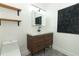 Modern bathroom with wood vanity, subway tile, and black fixtures at 2580 Grassy Point Dr # 102, Lake Mary, FL 32746