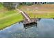 Wooden dock on a pond with lily pads at 2580 Grassy Point Dr # 102, Lake Mary, FL 32746