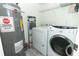 Convenient laundry room with washer, dryer, and shelving at 2580 Grassy Point Dr # 102, Lake Mary, FL 32746