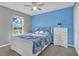 Bedroom featuring a white sleigh bed and blue walls at 2655 Trafalgar Blvd, Kissimmee, FL 34758