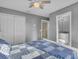 Bedroom with blue bedding and en-suite bathroom access at 2655 Trafalgar Blvd, Kissimmee, FL 34758