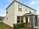 Two-story home with stone pillar accents, brown trim and a well-manicured front lawn enhance curb appeal at 2655 Trafalgar Blvd, Kissimmee, FL 34758