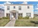 Two-story house with a white exterior, stone accents, and a landscaped lawn at 2655 Trafalgar Blvd, Kissimmee, FL 34758