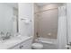 Bathroom featuring a tiled shower-tub combination, sleek vanity with a white countertop and a mirror at 2904 On The Rocks Pt, Kissimmee, FL 34747