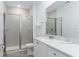 Well-lit bathroom featuring tiled shower, sleek vanity with a white countertop and a large mirror at 2904 On The Rocks Pt, Kissimmee, FL 34747