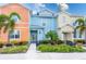 Three colorful townhouses with landscaping and walkways at 2904 On The Rocks Pt, Kissimmee, FL 34747