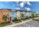 Row of colorful townhouses with parking at 2904 On The Rocks Pt, Kissimmee, FL 34747