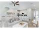 Bright living room with white couch and kitchen view at 2904 On The Rocks Pt, Kissimmee, FL 34747