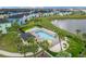 Community pool with lounge chairs and a cabana at 2904 On The Rocks Pt, Kissimmee, FL 34747