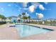 Community pool with lounge chairs and a volleyball net at 2904 On The Rocks Pt, Kissimmee, FL 34747