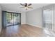 Bedroom with hardwood floors, ceiling fan, and sliding glass doors at 30 Sheoah Blvd # 18, Winter Springs, FL 32708