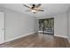 Bedroom with hardwood floors, ceiling fan, and sliding glass doors at 30 Sheoah Blvd # 18, Winter Springs, FL 32708