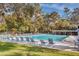 Community swimming pool with lounge chairs at 30 Sheoah Blvd # 18, Winter Springs, FL 32708