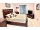 Bright bedroom featuring a king-size bed and neutral decor at 303 Palmview Ct, Kissimmee, FL 34743