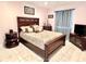 Spacious bedroom with dark wood furniture and decorative pillows at 303 Palmview Ct, Kissimmee, FL 34743