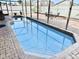 Inviting rectangular pool with paver deck and screened enclosure at 303 Palmview Ct, Kissimmee, FL 34743