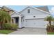 Two-story house with gray siding, a white door, and a two-car garage at 3092 Prelude Ln, Kissimmee, FL 34746