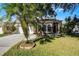 Tan house with white garage door, palm trees, and landscaped yard at 3427 Kayla Cir, Oviedo, FL 32765