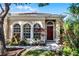 House with red door, arched windows, and lush landscaping at 3427 Kayla Cir, Oviedo, FL 32765