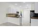 Modern kitchen with granite countertops and white cabinets at 3427 Kayla Cir, Oviedo, FL 32765